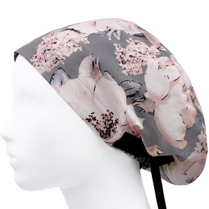 May include: Grey and pink floral print scrub hat with black ties.
