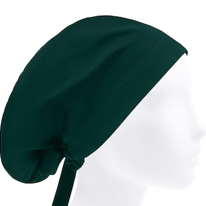 May include: A dark green scrub cap, designed to cover the head. The cap is made of a smooth fabric and features a tie in the back for an adjustable fit. The cap is shown on a white mannequin head.