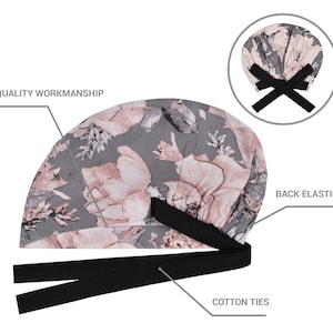 May include: A grey and pink floral print surgical scrub hat with black cotton ties and an elastic back. The hat is made with quality workmanship.