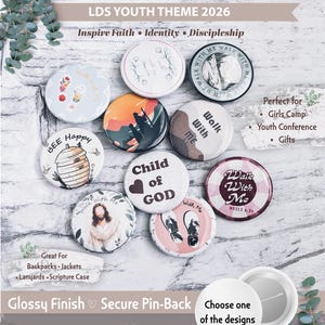 May include: A collection of glossy pin buttons with various designs, including text and illustrations. The buttons feature phrases like "Walk With Me" and "Child of God." The text "LDS YOUTH THEME 2026" is also visible.
