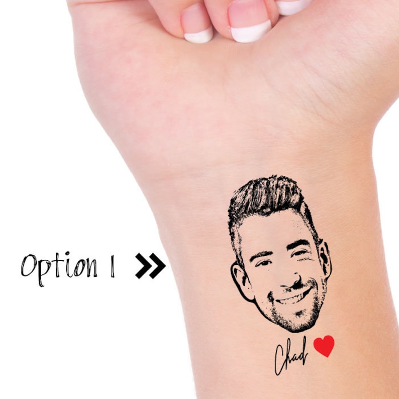 May include: A temporary tattoo featuring a black and white illustration of a man's face with a smiling expression. The tattoo also includes the word "Chad" in cursive handwriting and a red heart.