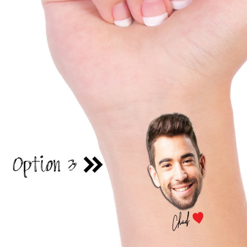 May include: A temporary tattoo featuring a man's face with a smiling expression. The tattoo also includes the name "Chad" and a red heart.