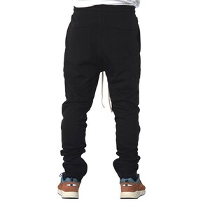 May include: Black sweatpants with a drawstring waist and a relaxed fit.