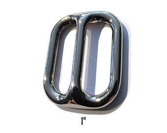 May include: A silver metal slider buckle, 1 inch in size. The buckle has two oval-shaped openings.