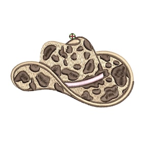 May include: A brown and tan cowboy hat with a camouflage pattern. The hat has a pink band around the crown.