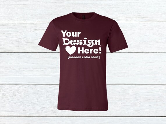 Maroon Bella Canvas 3001 T-Shirt Mockup Wood Background Maroon Bella Canvas 3001 T-Shirt Mockup Wood Background