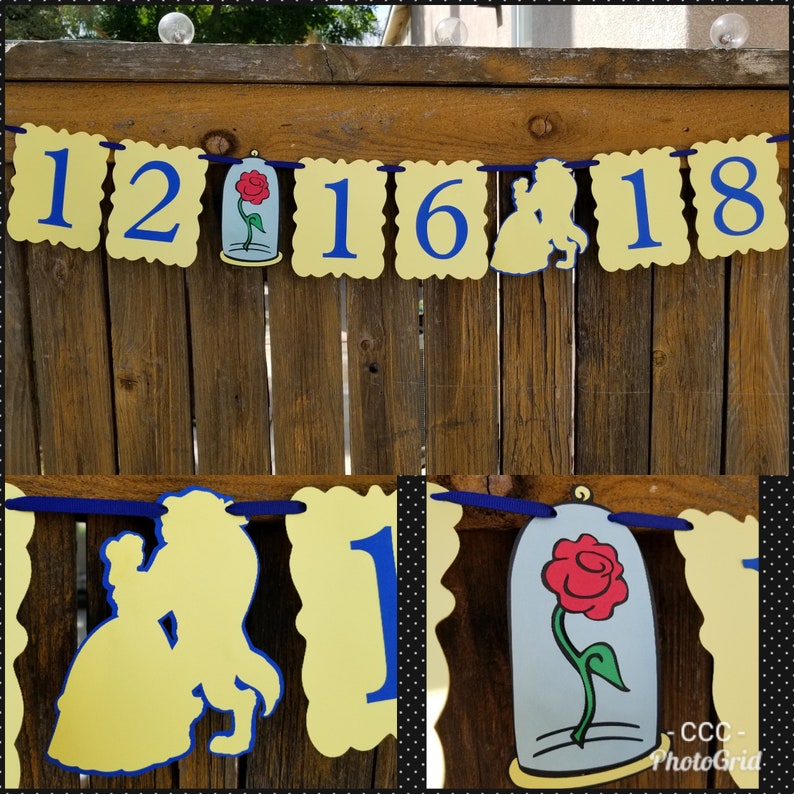May include: A yellow and blue banner with the numbers 12, 16, 18 and a silhouette of Belle and the Beast. The banner also features a red rose in a glass dome.