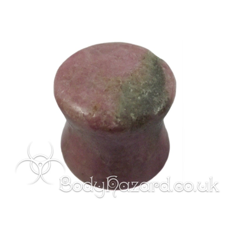 May include: A pair of pink and gray stone ear gauges. The gauges are flared and have a smooth, polished finish.