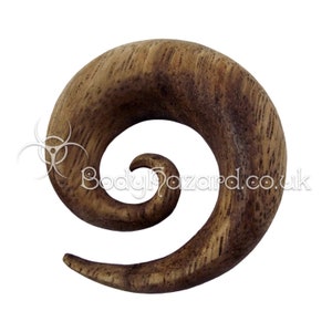 May include: A wooden spiral ear gauge, with a dark brown colour and a smooth, polished finish.