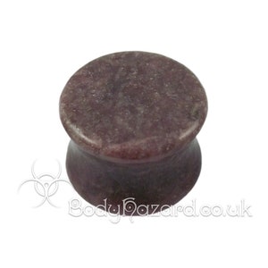 May include: Purple and gray stone ear gauge plug. The plug is a flared style with a smooth, polished finish.