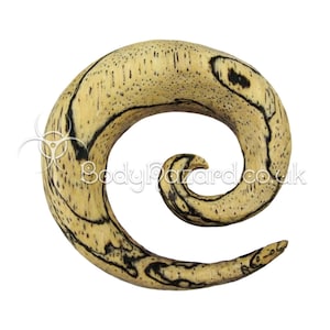 May include: A spiral wooden ear gauge with a light brown and black wood grain pattern. The gauge is made of natural wood and has a unique spiral design.
