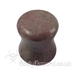 May include: A pair of pink and gray stone ear gauges. The gauges are flared and have a smooth, polished finish.