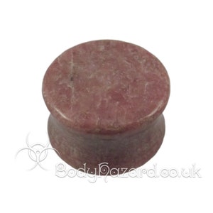 May include: A pair of pink and white stone ear gauges. The gauges are made of a natural stone with a marbled pattern.