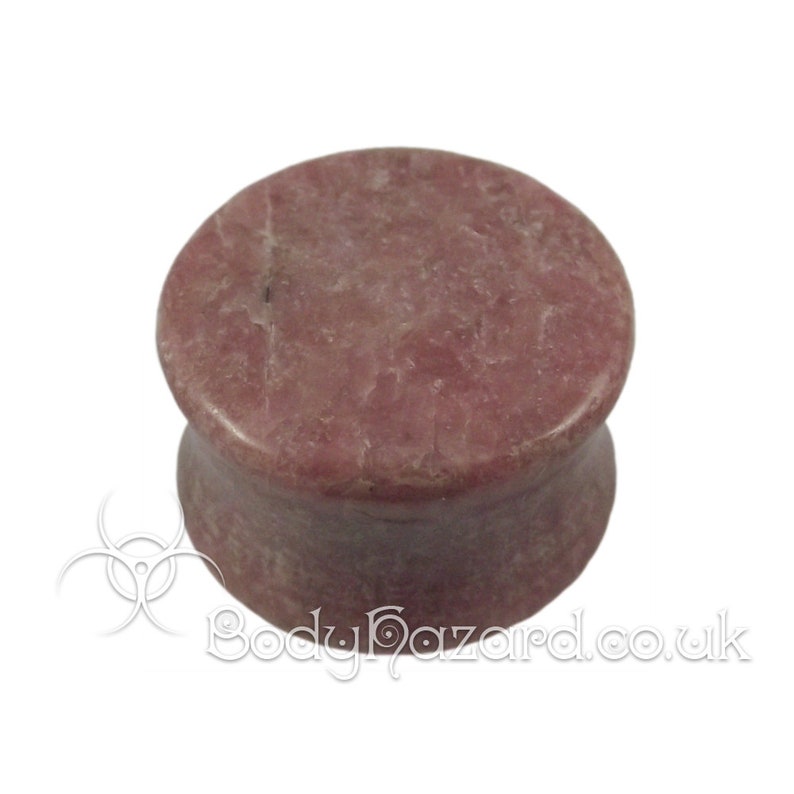 May include: A pair of pink and white stone ear gauges. The gauges are made of a natural stone with a marbled pattern.