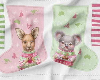 May include: A fabric pattern for a Christmas stocking featuring two different designs. One design features a kangaroo wearing a red and green sweater holding a red ornament. The other design features a koala wearing a red and green sweater holding a plate of cookies. Both designs are on a pink and green background with snowflakes and Christmas trees.