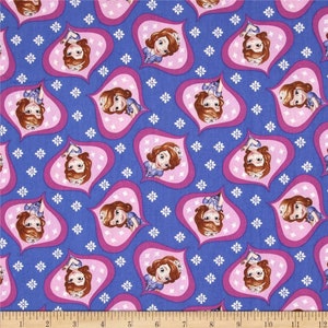 May include: Purple fabric with a repeating pattern of a cartoon princess in a pink heart-shaped frame. The princess is wearing a blue dress and a crown. The background is filled with white flowers.