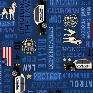 May include: Blue fabric with a repeating pattern of police cars, police badges, American flags, and text related to police work. The text includes "10-4", "cop", "officer", "brave", "dependable", "protect", "enforce", "guard", "trustworthy", "honor", "finest", "serve", and "upholding the law".