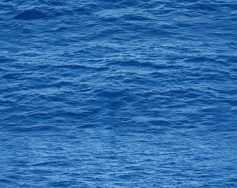 May include: A close-up of the sea's surface, displaying a deep blue hue. The gentle waves form a textured pattern across the water, with slight variations in light and shadow. The image captures the natural beauty of the ocean.