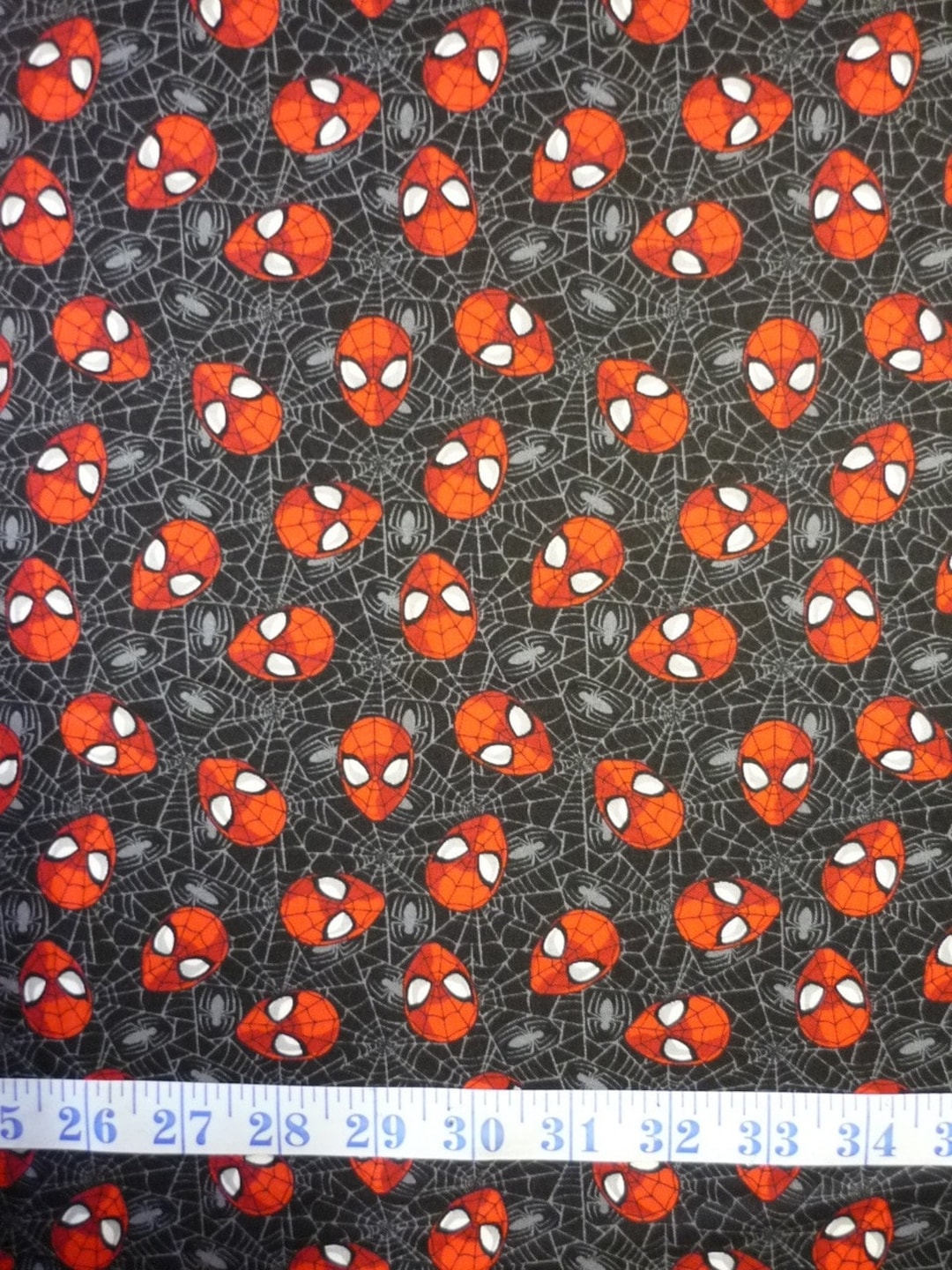 spiderman-heads-and-web-backbround-black-marvel-comics-cotton-quilting