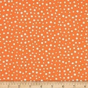 May include: Orange fabric with a white polka dot pattern. The dots are of varying sizes and are scattered randomly across the fabric.