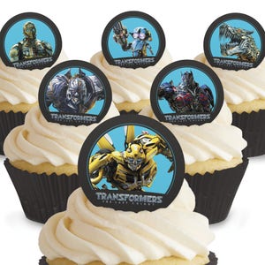 Op de afbeelding: Zes ronde cupcake-toppers met personages uit de Transformers-filmfranchise. De toppers zijn gedrukt op een witte achtergrond met een blauwe rand en bevatten het Transformers-logo. De personages omvatten Optimus Prime, Bumblebee, Megatron en anderen.