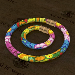 May include: A colourful beaded necklace and bracelet set with a floral pattern. The necklace and bracelet are made of small, colourful beads and have gold-toned clasps.