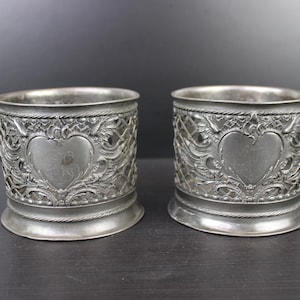 Art Nouveau pair of pewter bottle holders coasters.