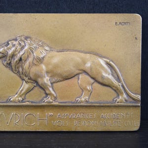Art Deco small plaque of a lion by E Monti