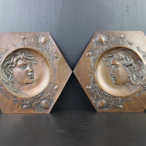 Art Nouveau pair of copper wall plaques.