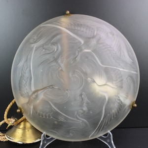 Art Deco pressed glass lamp with bird and fish.
