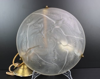 Art Deco pressed glass lamp with bird and fish.