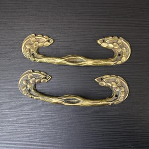 Art Nouveau pair of bronze floral furniture drawer handles.