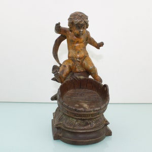 Antique fishing boy figurine above barrel by August moreau.