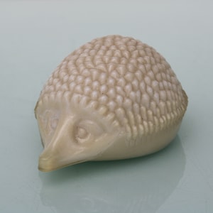 Art Deco pressed glass paper weight of a hedgehog.