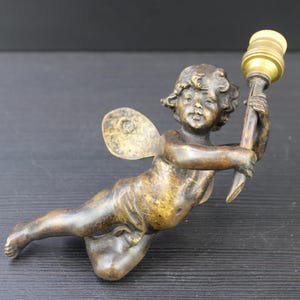 Antique solid bronze ornament part of a lamp cherub.