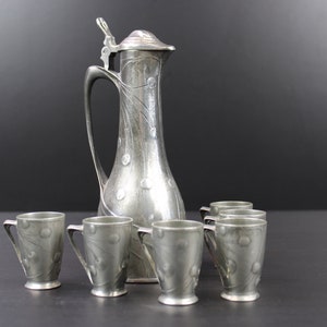 Art Nouveau pewetr liqueur set 6 cups with decanter & jug.