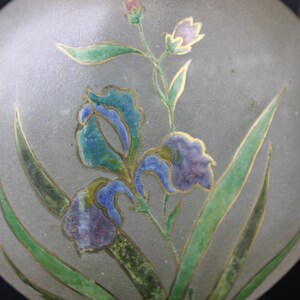 May include: A frosted glass orb with a gold-trimmed floral design. The design features blue, green, and purple irises with gold accents.