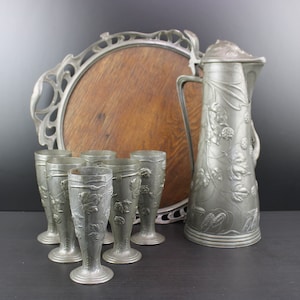 Art Nouveau large floral pewter wine set platter cups and decanter.