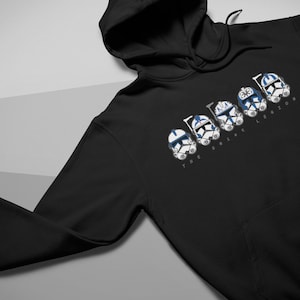 May include: Black hooded sweatshirt with a white graphic of five clone trooper helmets from the Star Wars franchise. The text "The Bad Batch" is printed below the helmets.
