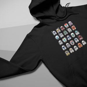 May include: Black hooded sweatshirt with a graphic print of multiple colorful clone trooper helmets from the Star Wars franchise.