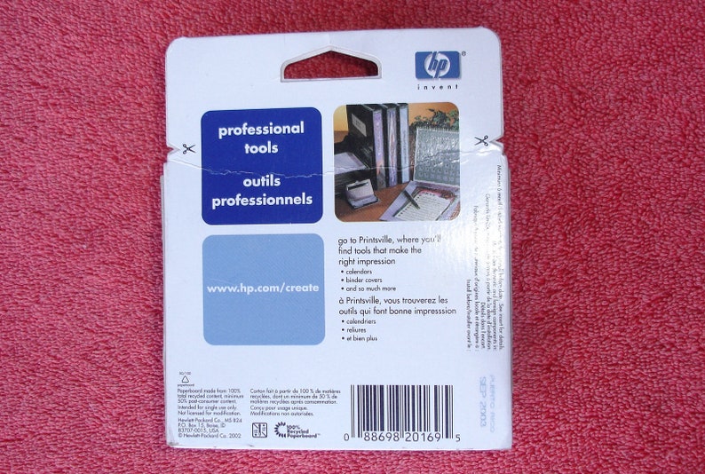 May include: A white cardboard package with a blue and white logo that says "hp invent". The package has a blue and white label that says "professional tools" and "outils professionnels". The package also has a barcode and the text "www.hp.com/create".