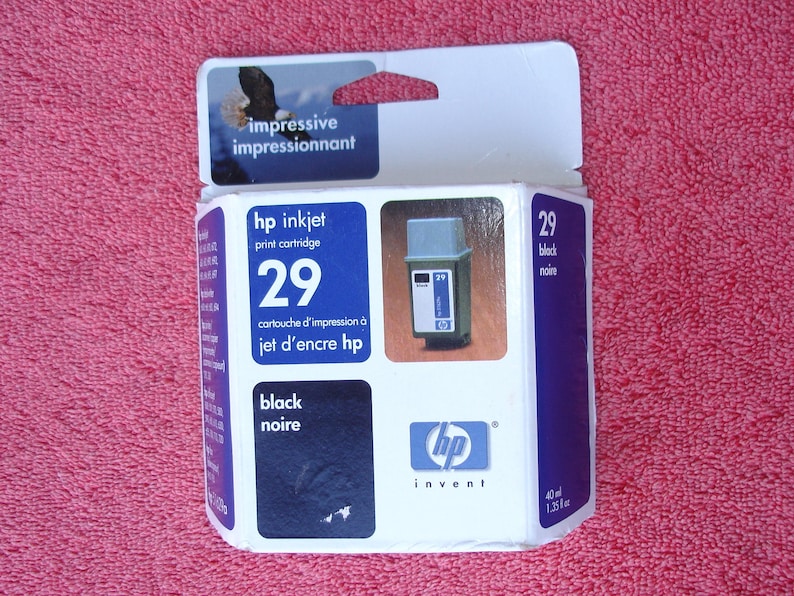 May include: A white box with blue and black accents for an HP 29 black inkjet print cartridge. The box has the text "impressive impressionnant" on the top and "hp invent" on the bottom. The cartridge is for use with HP inkjet printers.