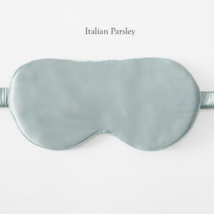 May include: A light blue sleep mask made of silk. The mask has an elastic band for a comfortable fit.