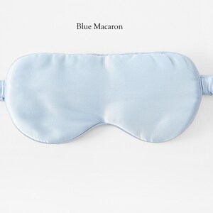 May include: A light blue sleep mask made of silk. The mask has an elastic strap.