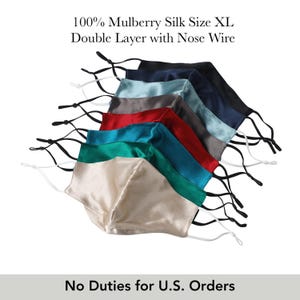May include: A collection of XL silk face masks in various colors, including cream, teal, red, and navy. Each mask is double-layered with a nose wire and adjustable ear loops. The text on the image reads "100% Mulberry Silk Size XL Double Layer with Nose Wire."