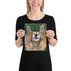 May include: A golden retriever dog lying on its back with its paws in the air, smiling with its tongue out. The dog is surrounded by green grass.