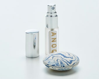 Gift box 3 pieces: an aromatic pebble diffuser, a 5ml perfume concentrate spray, and a organza gift bag. ANOQ Collection