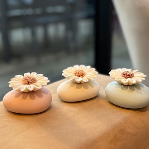 Set of 3 ceramic fragrance diffuser vases. Beige, blue, and pink colored vases with handmade daisy-shaped natural diffuser flowers. 3 pces