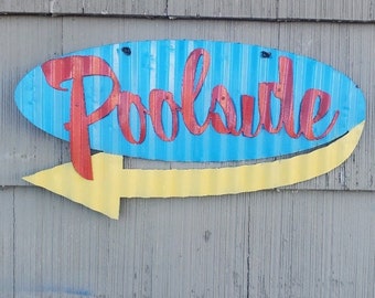 May include: A blue and yellow metal sign with the word "Poolside" in red lettering and a yellow arrow pointing to the right.
