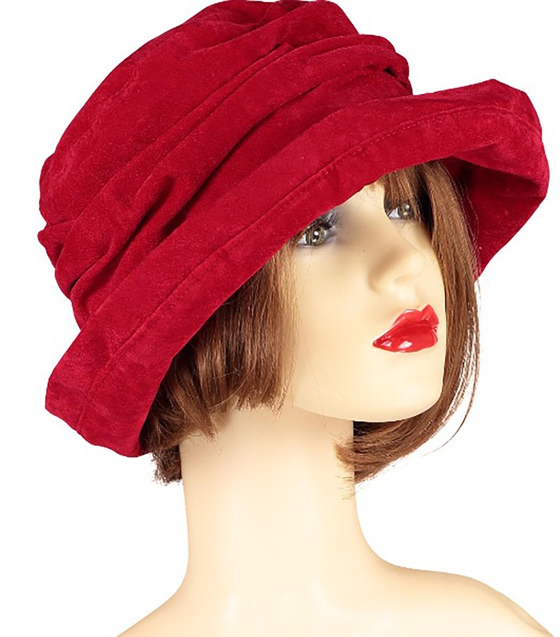 May include: A red velvet cloche hat with a gathered crown.